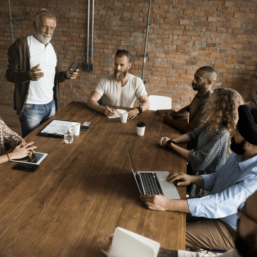 Poor team-building ideas, group at table. Credit rawpixel