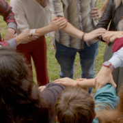 Group holding hards and arms in circle