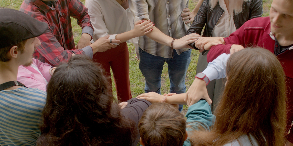 Group holding hards and arms in circle