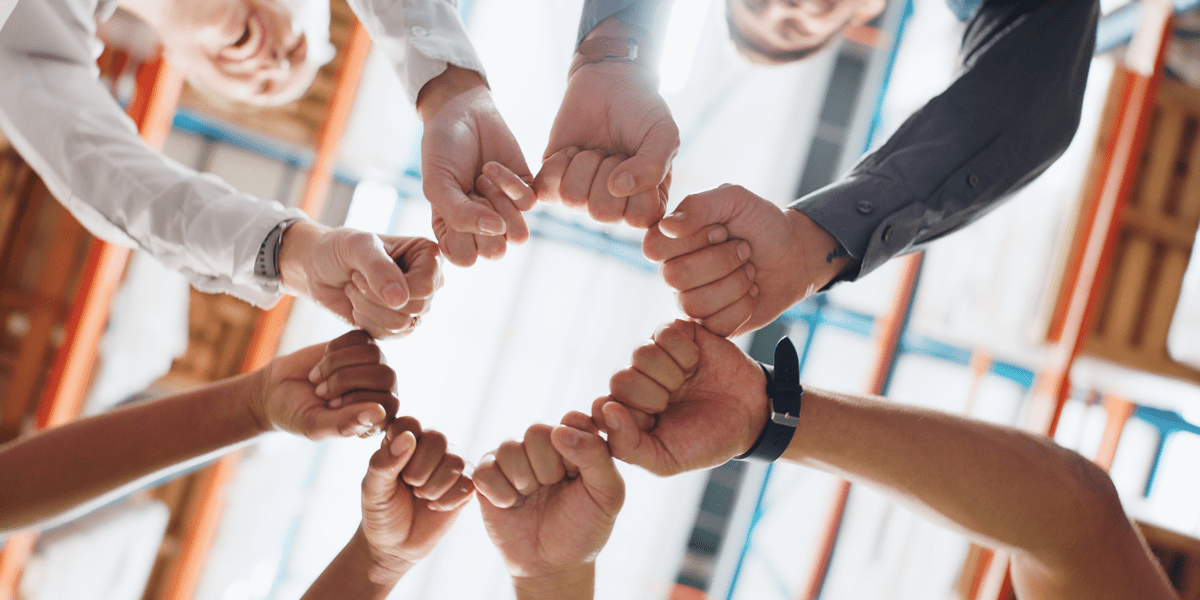 Small group team-building circle of fists